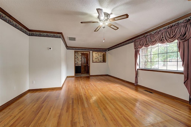 unfurnished living room featuring ceiling fan, crown molding, light wood-type flooring, and a textured ceiling