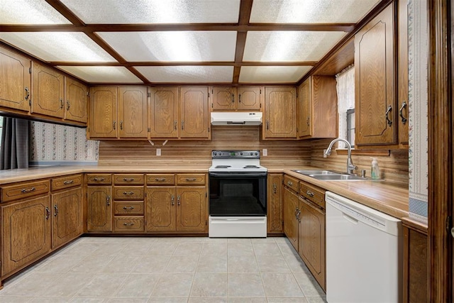 kitchen featuring backsplash, white appliances, sink, and light tile patterned floors