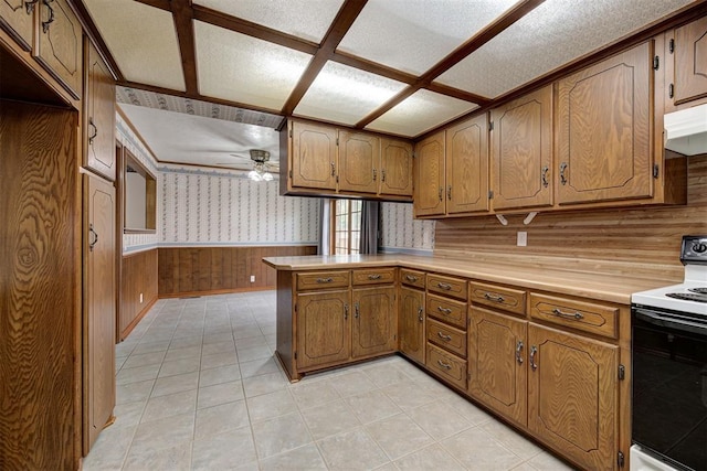 kitchen featuring ceiling fan, white electric range, kitchen peninsula, a textured ceiling, and light tile patterned floors