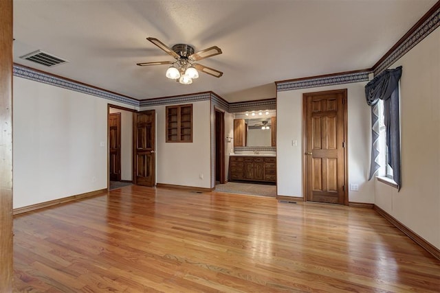 interior space with ceiling fan, light hardwood / wood-style floors, and ornamental molding