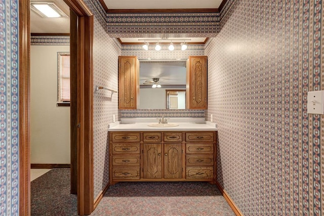 bathroom with ceiling fan, ornamental molding, and vanity