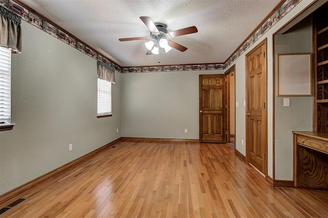 unfurnished bedroom with ceiling fan, a textured ceiling, and light hardwood / wood-style flooring