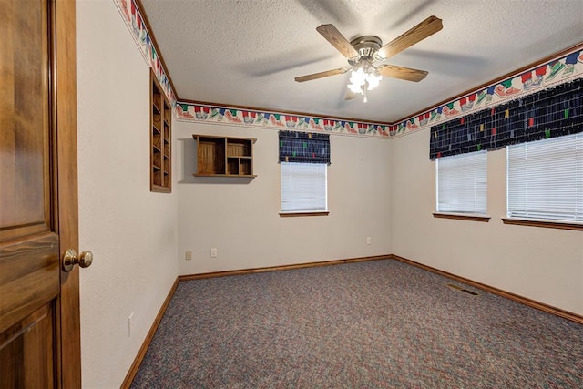 carpeted empty room with a textured ceiling and ceiling fan