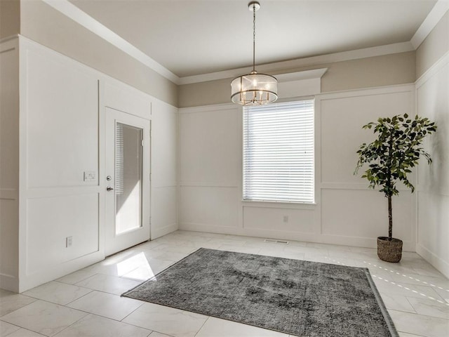 unfurnished dining area with a chandelier and ornamental molding