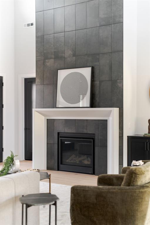 living room with hardwood / wood-style floors and a fireplace