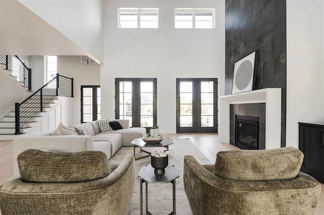 living room with plenty of natural light, french doors, and a high ceiling