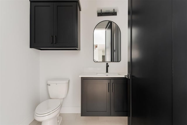 bathroom featuring tile patterned flooring, vanity, and toilet