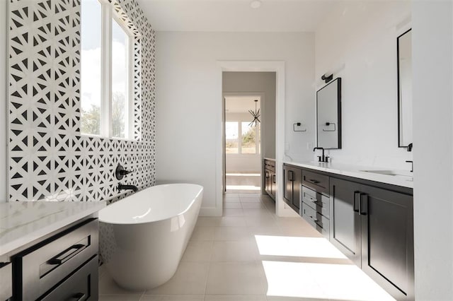 bathroom featuring a bath, vanity, and tile patterned floors