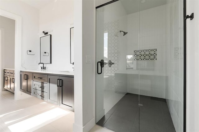 bathroom with tile patterned flooring, vanity, and a shower with shower door