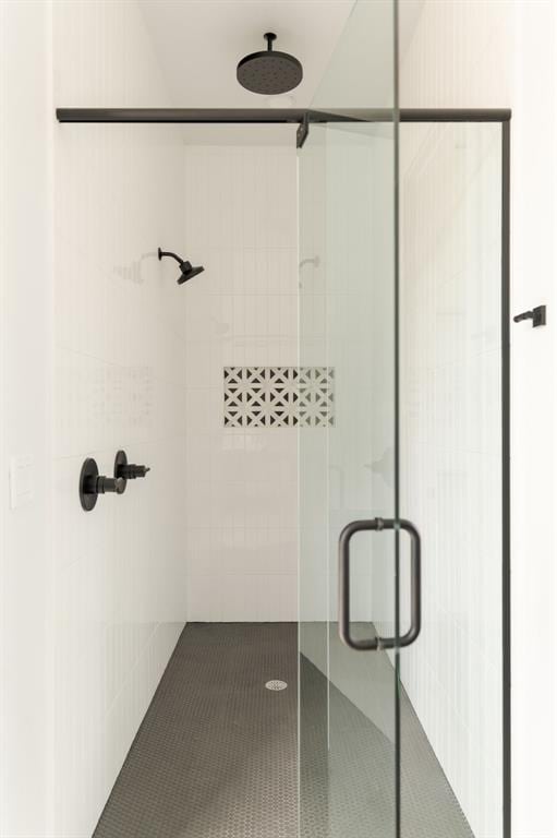 bathroom featuring a shower with shower door