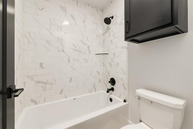 bathroom featuring toilet and tiled shower / bath