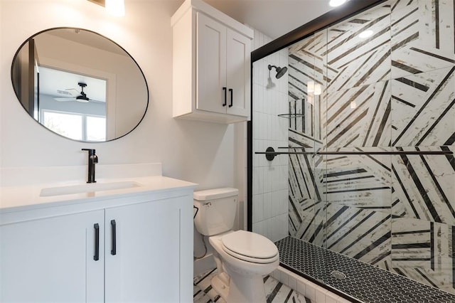 bathroom with vanity, a shower with door, tile patterned floors, ceiling fan, and toilet