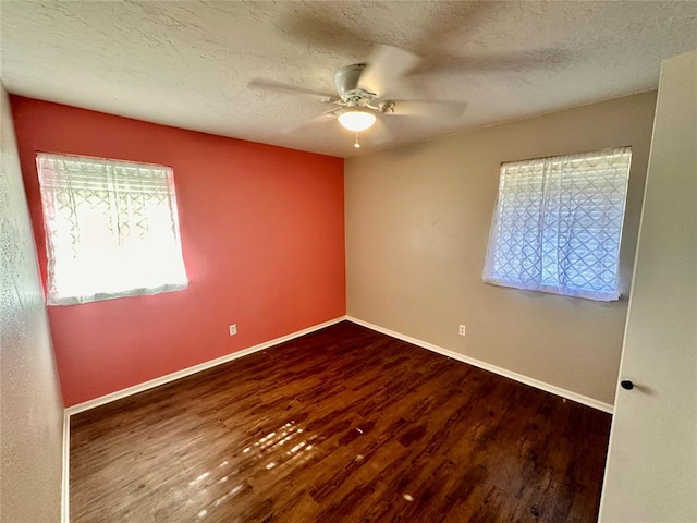 unfurnished room featuring a textured ceiling, dark hardwood / wood-style flooring, and ceiling fan