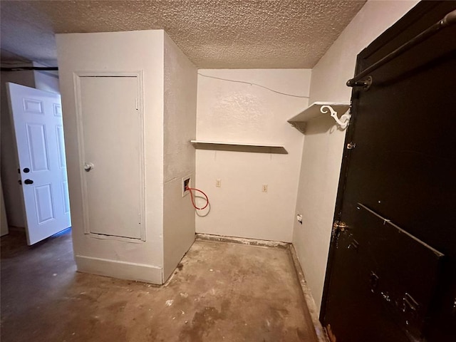 laundry area with washer hookup and a textured ceiling