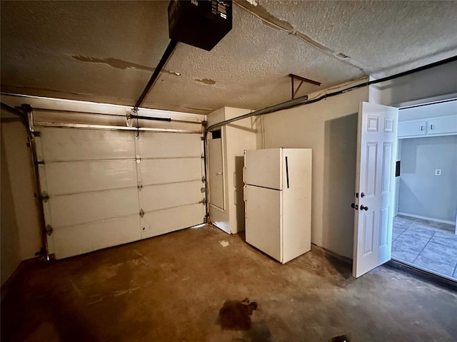 garage with white refrigerator and a garage door opener