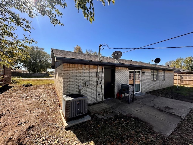 rear view of property featuring central AC and a patio area