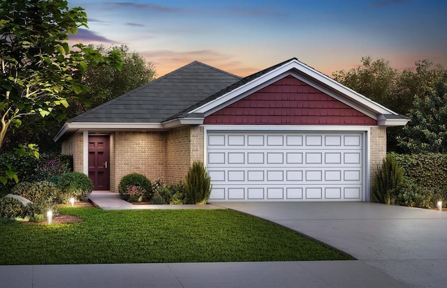 view of front of house featuring a garage and a lawn