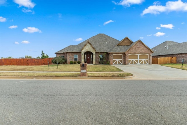 view of front of property featuring a front yard and a garage