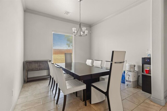 dining room featuring crown molding, light tile patterned floors, and a notable chandelier