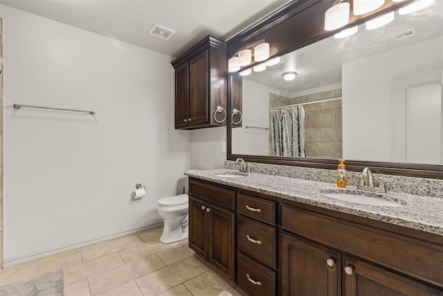 bathroom with tile patterned floors, vanity, toilet, and walk in shower