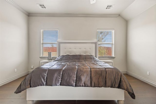 bedroom with crown molding, wood-type flooring, and lofted ceiling