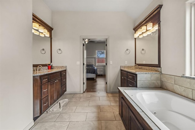 bathroom featuring tile patterned flooring, vanity, and a bathing tub