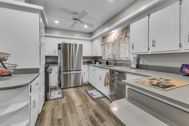 kitchen with white cabinets, sink, dark hardwood / wood-style floors, ceiling fan, and stainless steel appliances