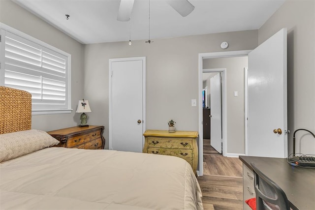 bedroom with light hardwood / wood-style floors and ceiling fan