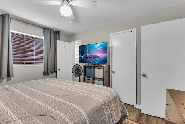 bedroom with dark hardwood / wood-style floors and ceiling fan