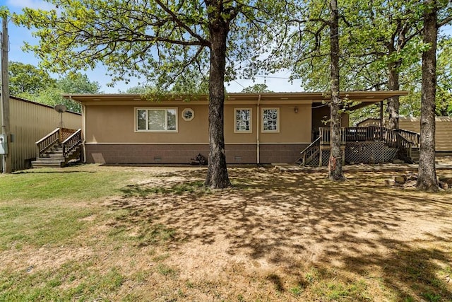 rear view of property featuring a yard