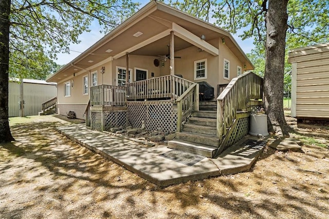 back of property with ceiling fan