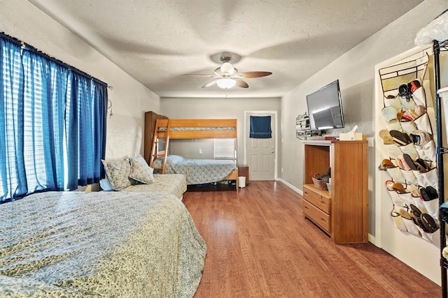 bedroom featuring wood-type flooring, a textured ceiling, and ceiling fan