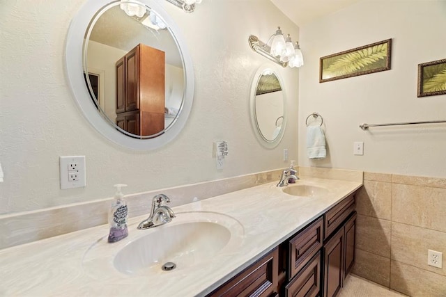 bathroom with vanity and tile walls