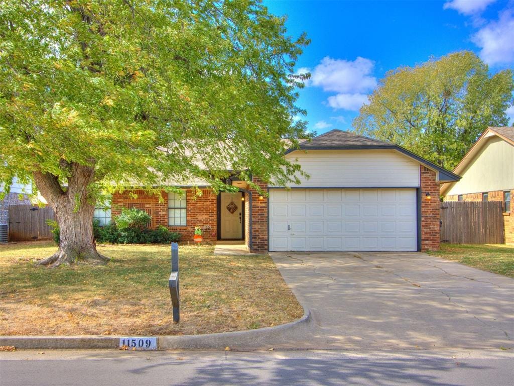 view of front of home with a garage and a front lawn