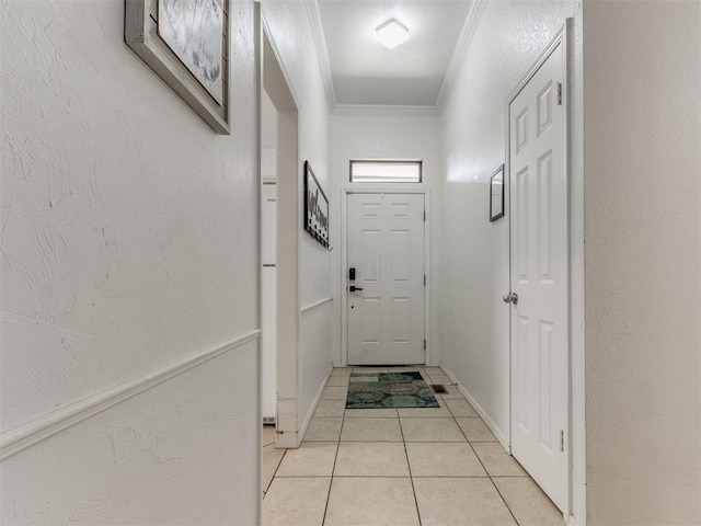 doorway featuring ornamental molding and light tile patterned floors