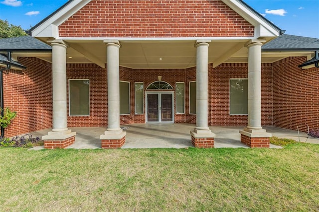 back of property featuring a lawn