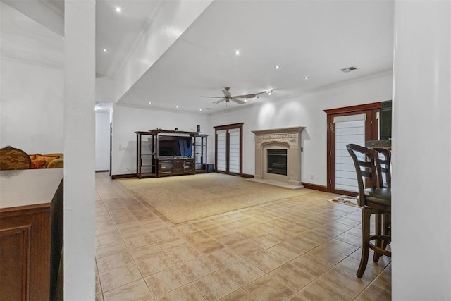 unfurnished living room with ceiling fan and light tile patterned floors