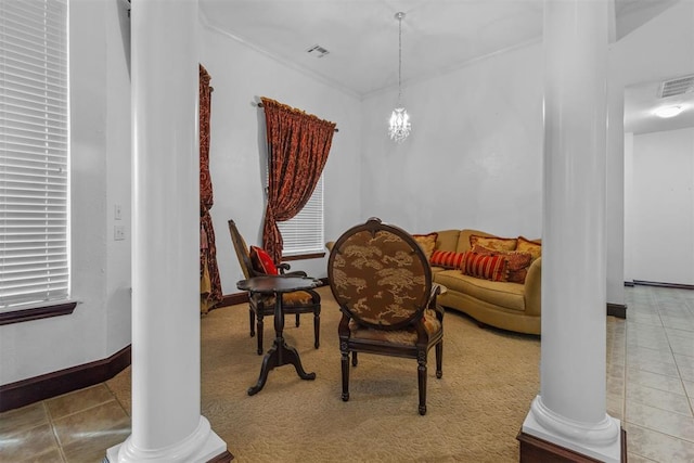 living area with a notable chandelier, light tile patterned floors, and decorative columns