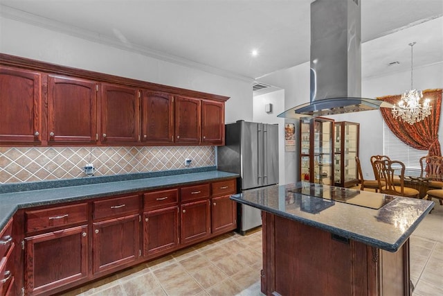 kitchen featuring a center island, exhaust hood, black electric cooktop, high end fridge, and a chandelier