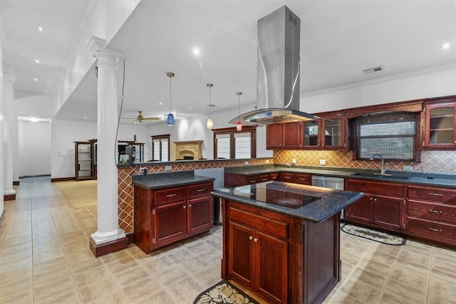 kitchen with a center island, sink, hanging light fixtures, decorative columns, and island range hood