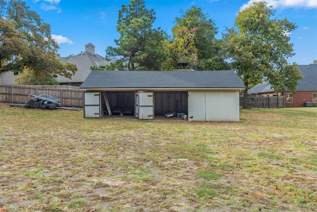 view of outbuilding featuring a lawn