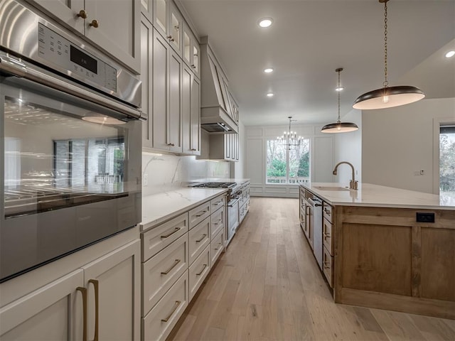 kitchen with light stone countertops, appliances with stainless steel finishes, and white cabinets