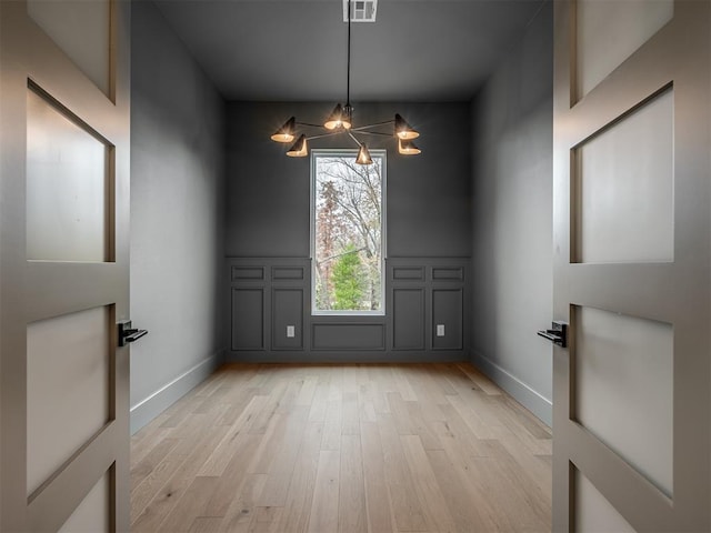 unfurnished room with light wood-type flooring