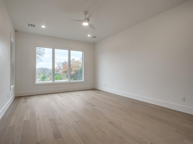 spare room with ceiling fan and light hardwood / wood-style flooring