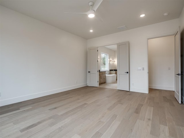 unfurnished bedroom with light wood-type flooring, ensuite bathroom, and ceiling fan