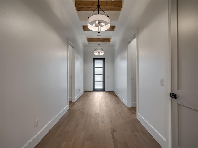 entryway with a tray ceiling and light hardwood / wood-style flooring