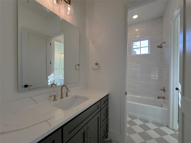 bathroom featuring vanity and tiled shower / bath