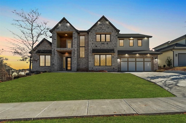 view of front of property featuring a garage and a yard