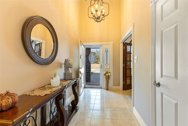 tiled entryway featuring a chandelier