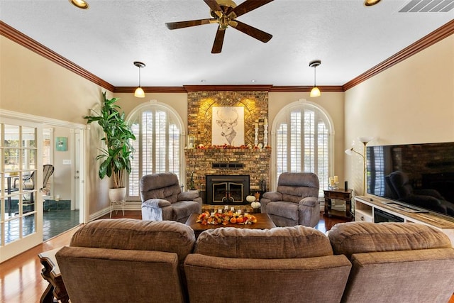 living room featuring ceiling fan, wood-type flooring, crown molding, and a wealth of natural light